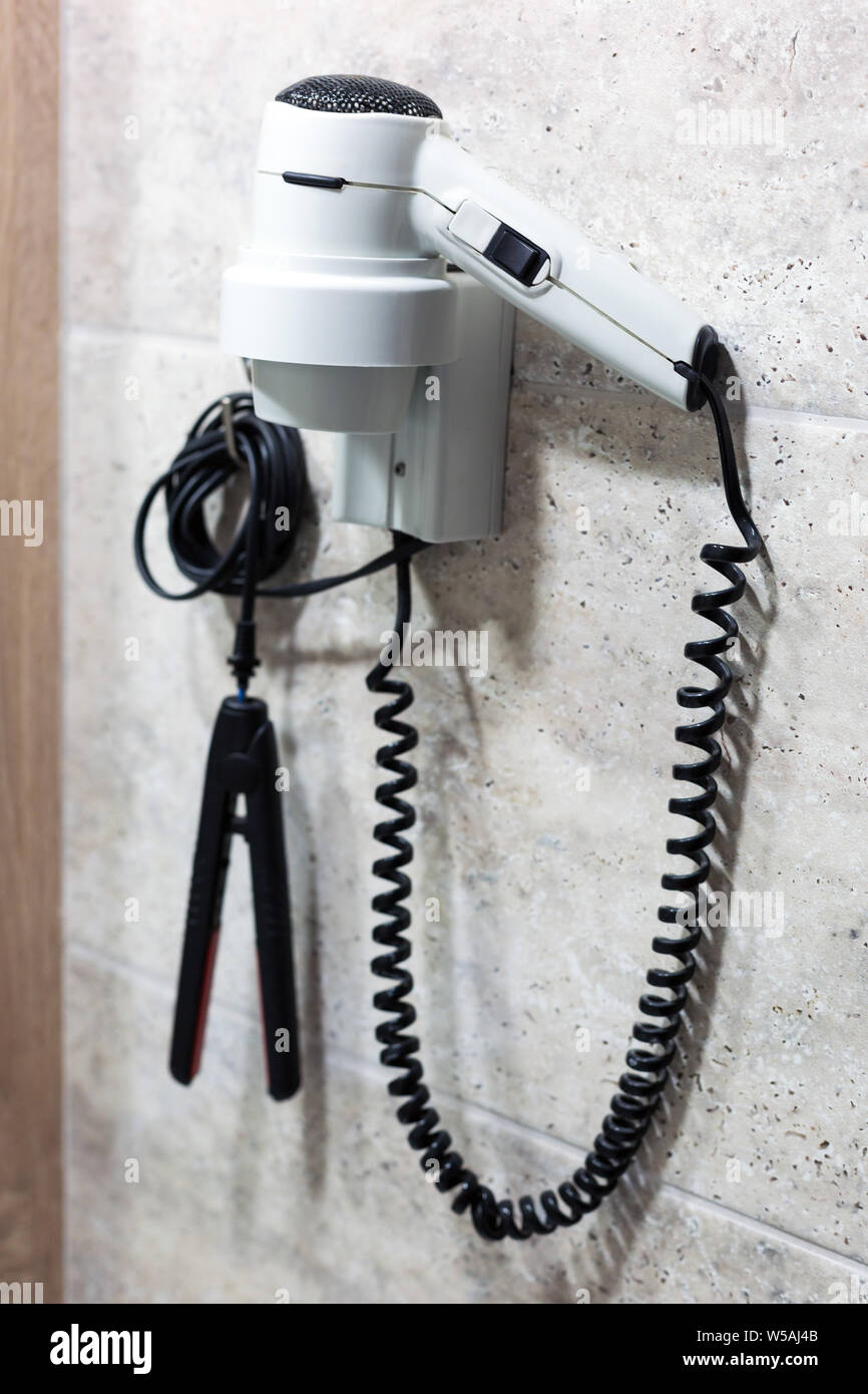Tools for hair care electric hair dryer and curling iron hang on the