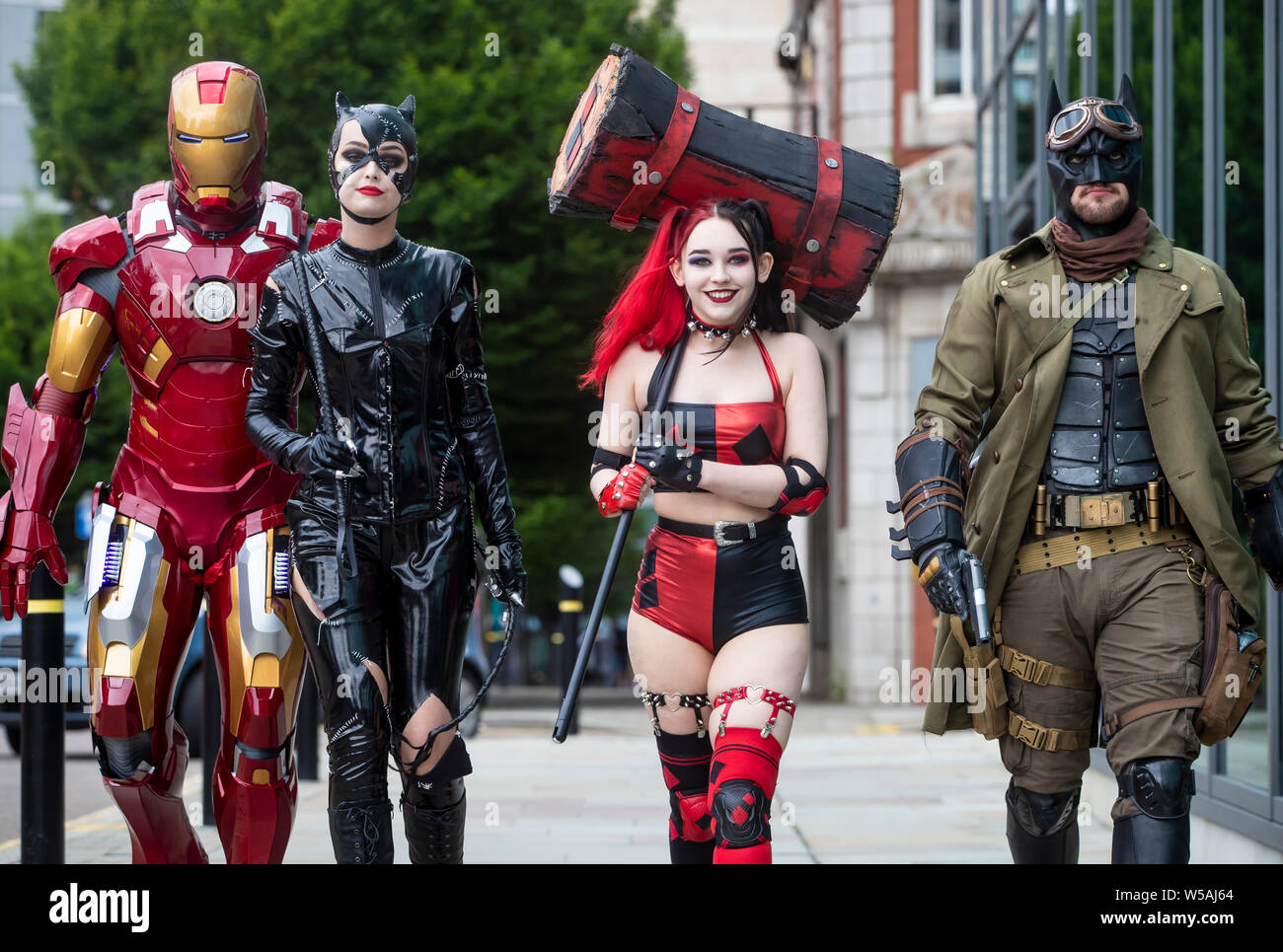 People dressed as characters (left to right) Iron Man, Cat woman, Harley Quinn from New 52 comics and Nightmare Batman during the MCM Manchester Comic Con which see thousands of sci-fi fans, gamers, comic collectors, movie buffs and anime enthusiasts visit Manchester Central. Stock Photo