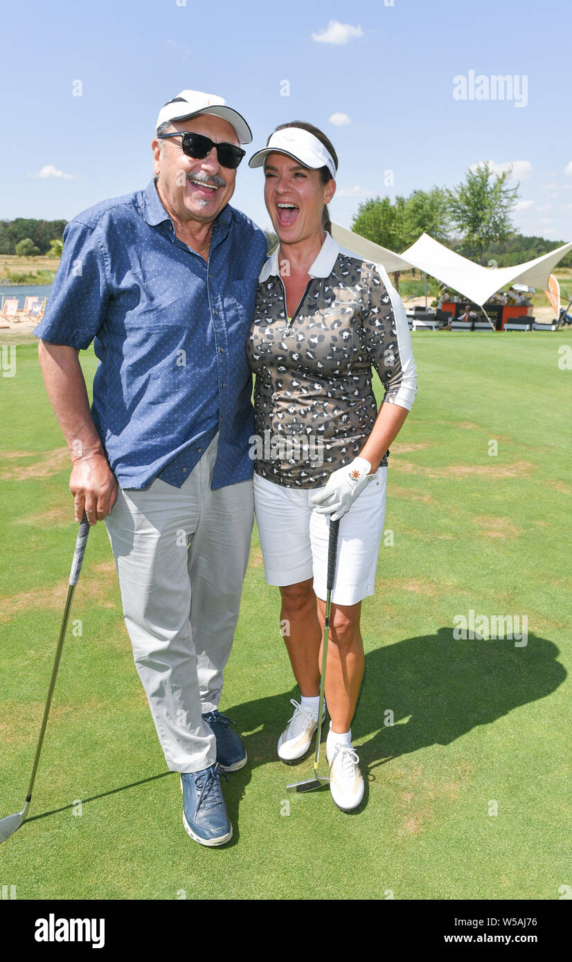 27 July 2019, Saxony, Machern: Wolfgang Stumph, actor, and Katarina Witt,  former figure skater, are on the course at the GRK-Golf-Charity Masters.  For the 12th time celebrities collect donations for charitable purposes