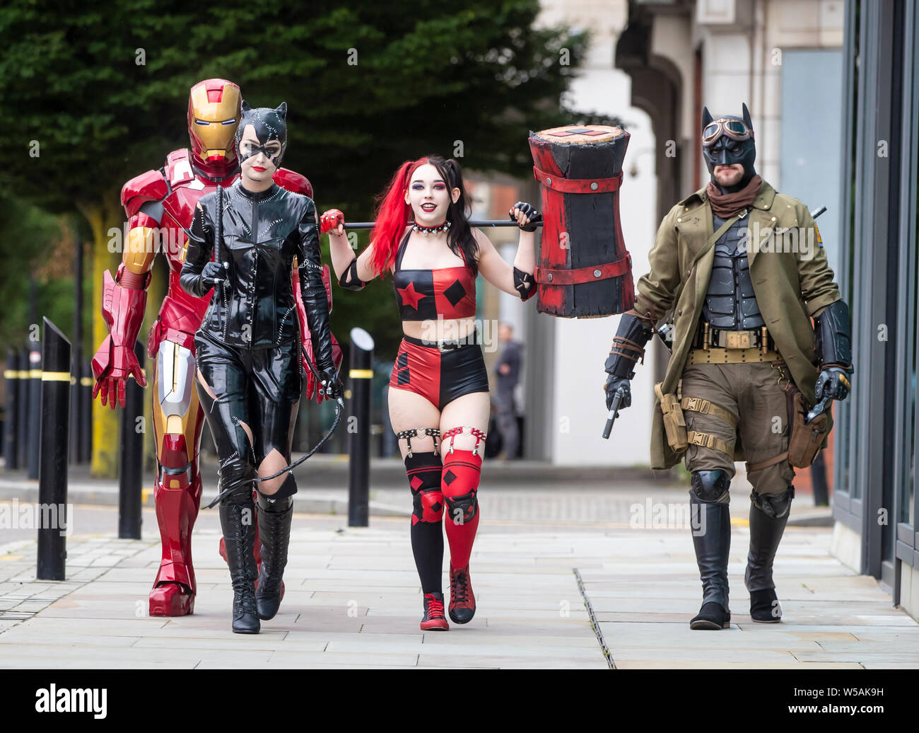 People dressed as characters (left to right) Iron Man, Cat woman, Harley Quinn from New 52 comics and Nightmare Batman during the MCM Manchester Comic Con which see thousands of sci-fi fans, gamers, comic collectors, movie buffs and anime enthusiasts visit Manchester Central. Stock Photo
