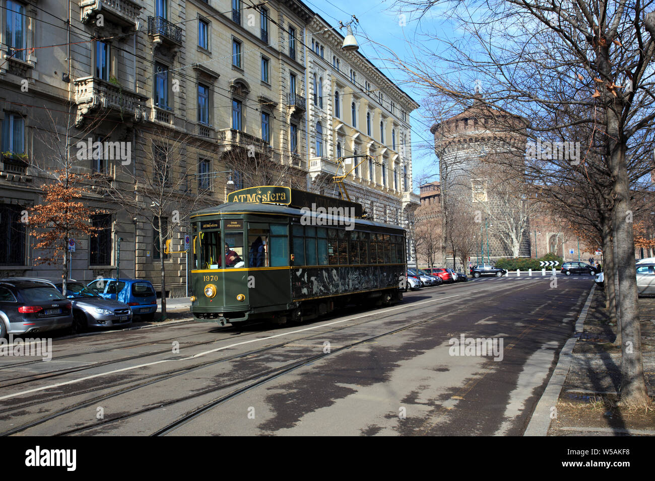 MILAN, ITALY - FEBRUARY 08, 2010 Old traditional tram ATM on the street of Milan used as moving restaurant ATMOSFERA on February 8, 2015. Milan tramwa Stock Photo