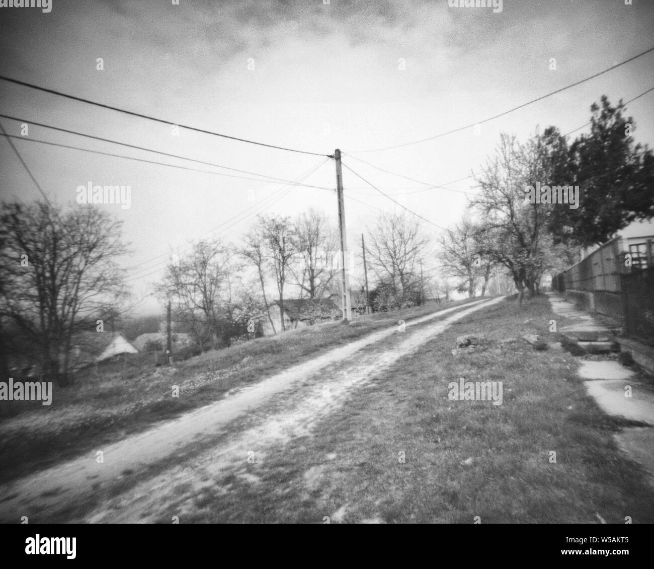 small road in a rural area, this black and white camera obscura photo is NOT sharp due to camera characteristic. Taken on analogue photographic large Stock Photo