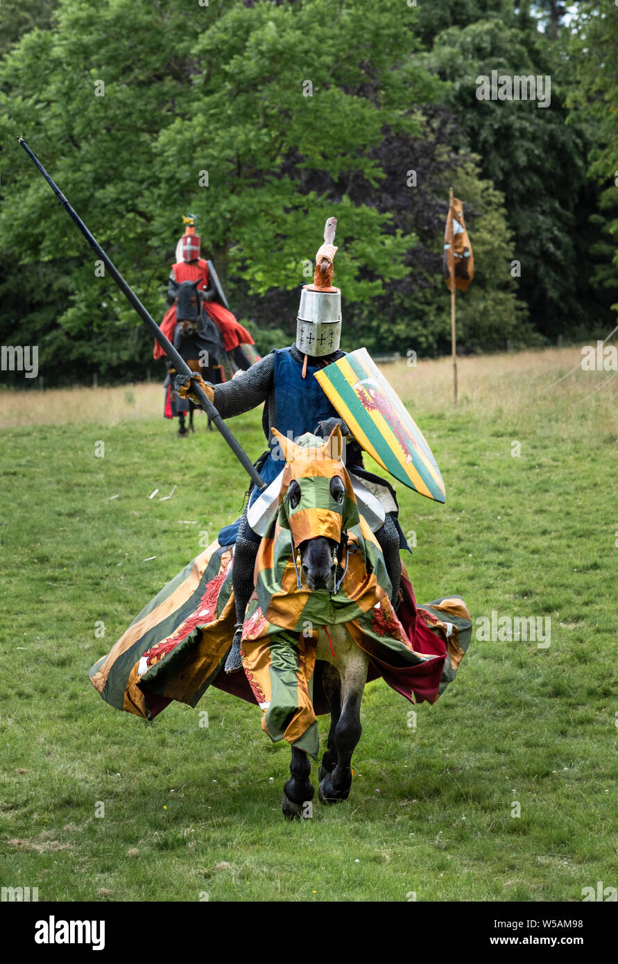 Mounted knights in medieval armour fighting on horseback during jousting demonstration Stock Photo