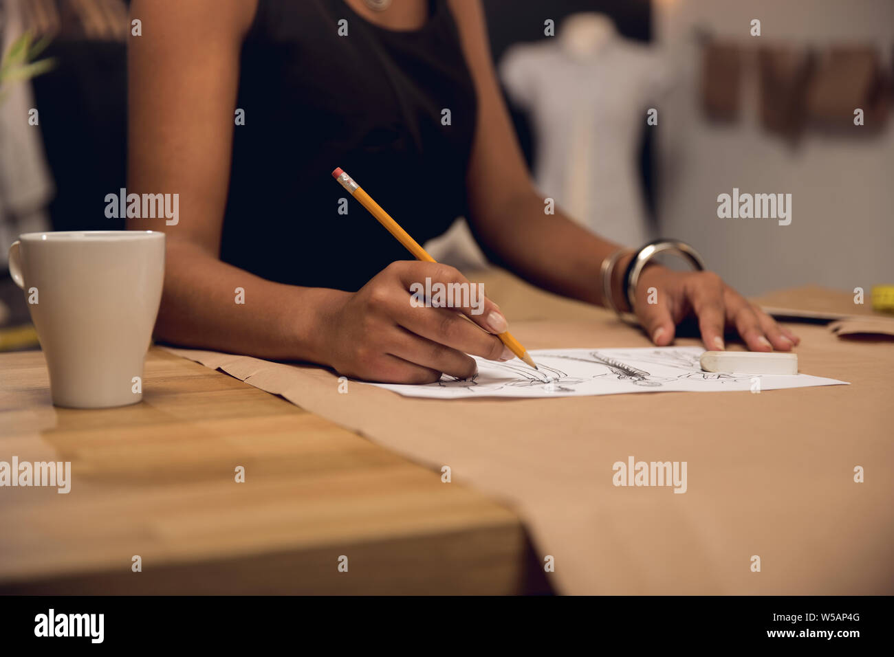 A young fashion designer working on her atelier Stock Photo - Alamy