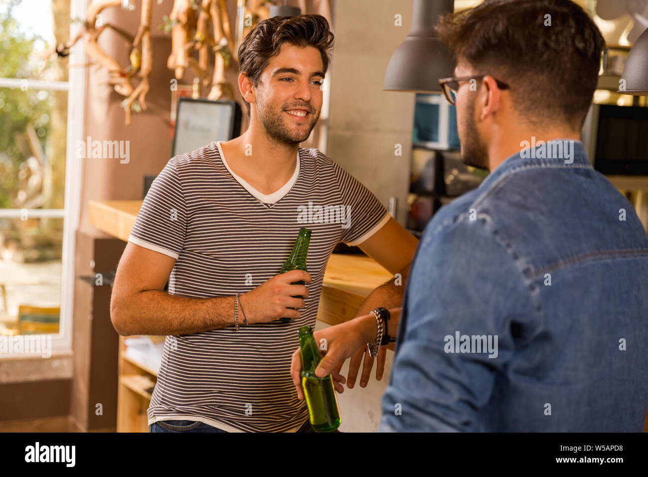 Two friends having a drink at the pub Stock Photo