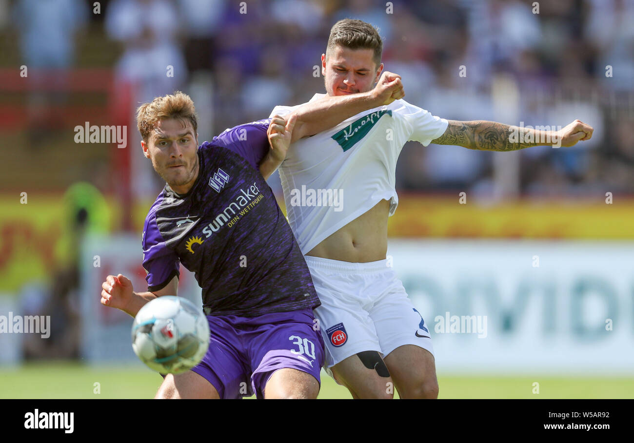 Osnabrück, Germany. 27th July, 2019.  2nd Bundesliga, VfL Osnabrück - 1st FC Heidenheim, 1st matchday in the stadium at the Bremer Brücke. Osnabrück's Benjamin Girth (l) in the fight for the ball with Marnon Busch (r) from Heidenheim. Photo: Friso Gentsch/dpa - IMPORTANT NOTE: In accordance with the requirements of the DFL Deutsche Fußball Liga or the DFB Deutscher Fußball-Bund, it is prohibited to use or have used photographs taken in the stadium and/or the match in the form of sequence images and/or video-like photo sequences. Credit: dpa picture alliance/Alamy Live News Stock Photo