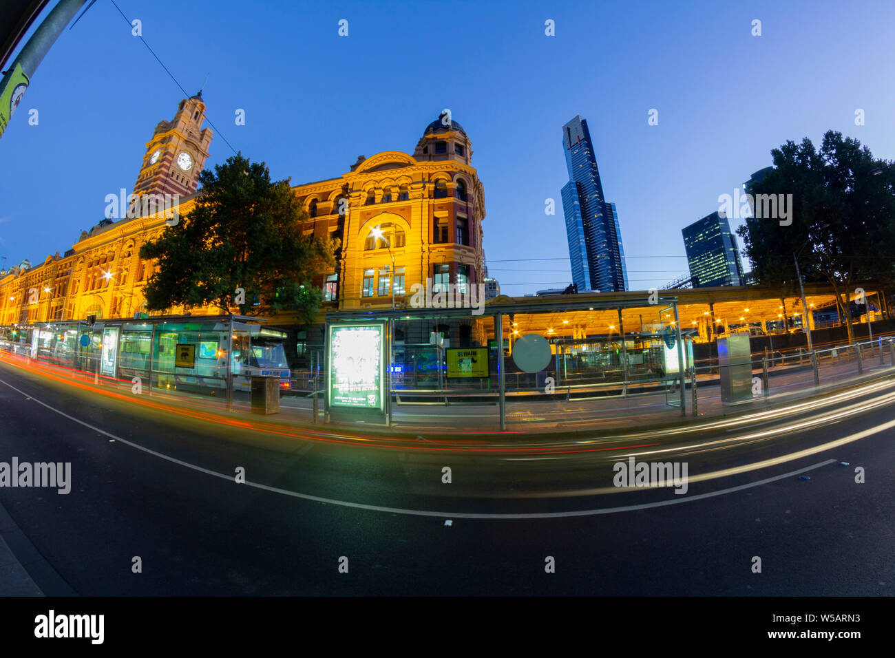 Melbourne, Victoria, Australia. Long exposure, trails, Night view of Flinders Street Station from street, a railway station on the corner of Flinders Stock Photo