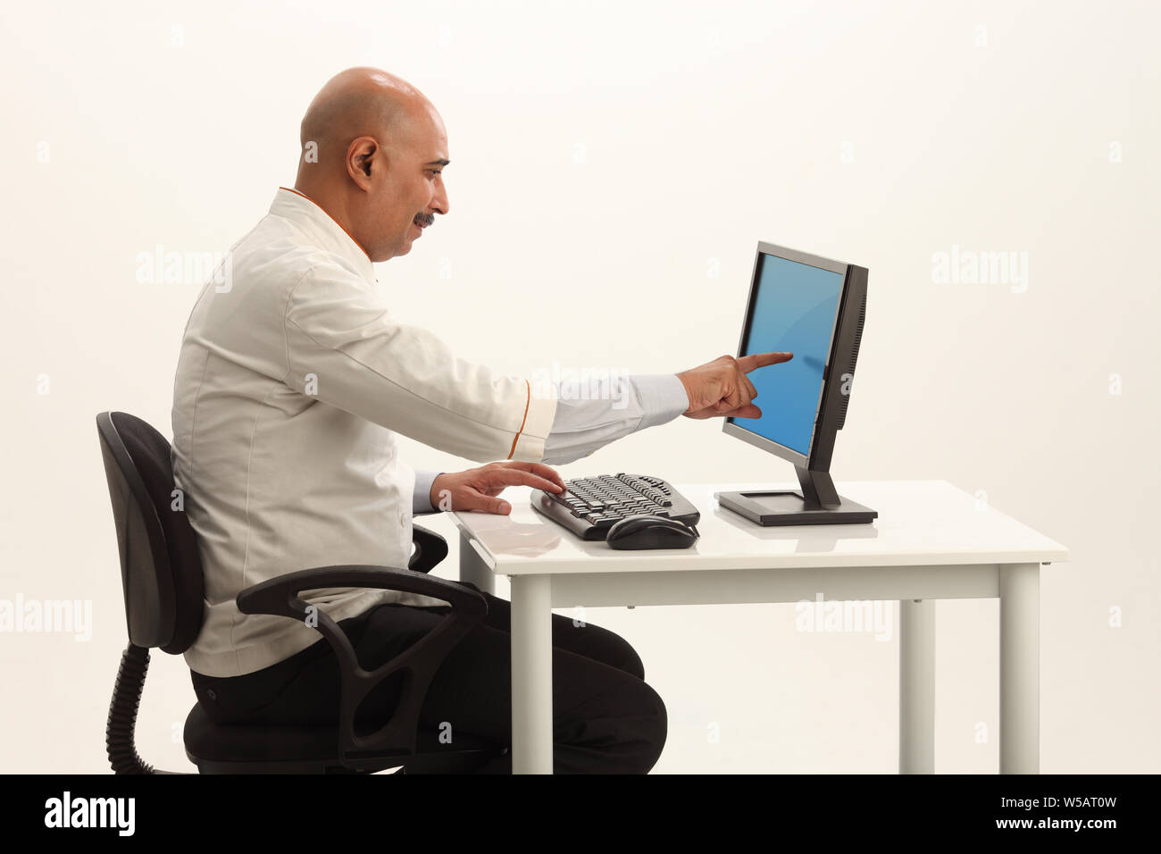 Man pointing monitor using mouse hi-res stock photography and images ...