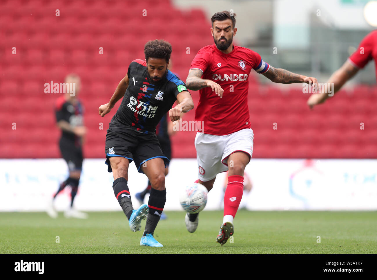 Crystal Palace Andros Townsend is challenged by Bristol City's Marlon Pack during the pre-season friendly match at Ashton Gate, Bristol. Stock Photo