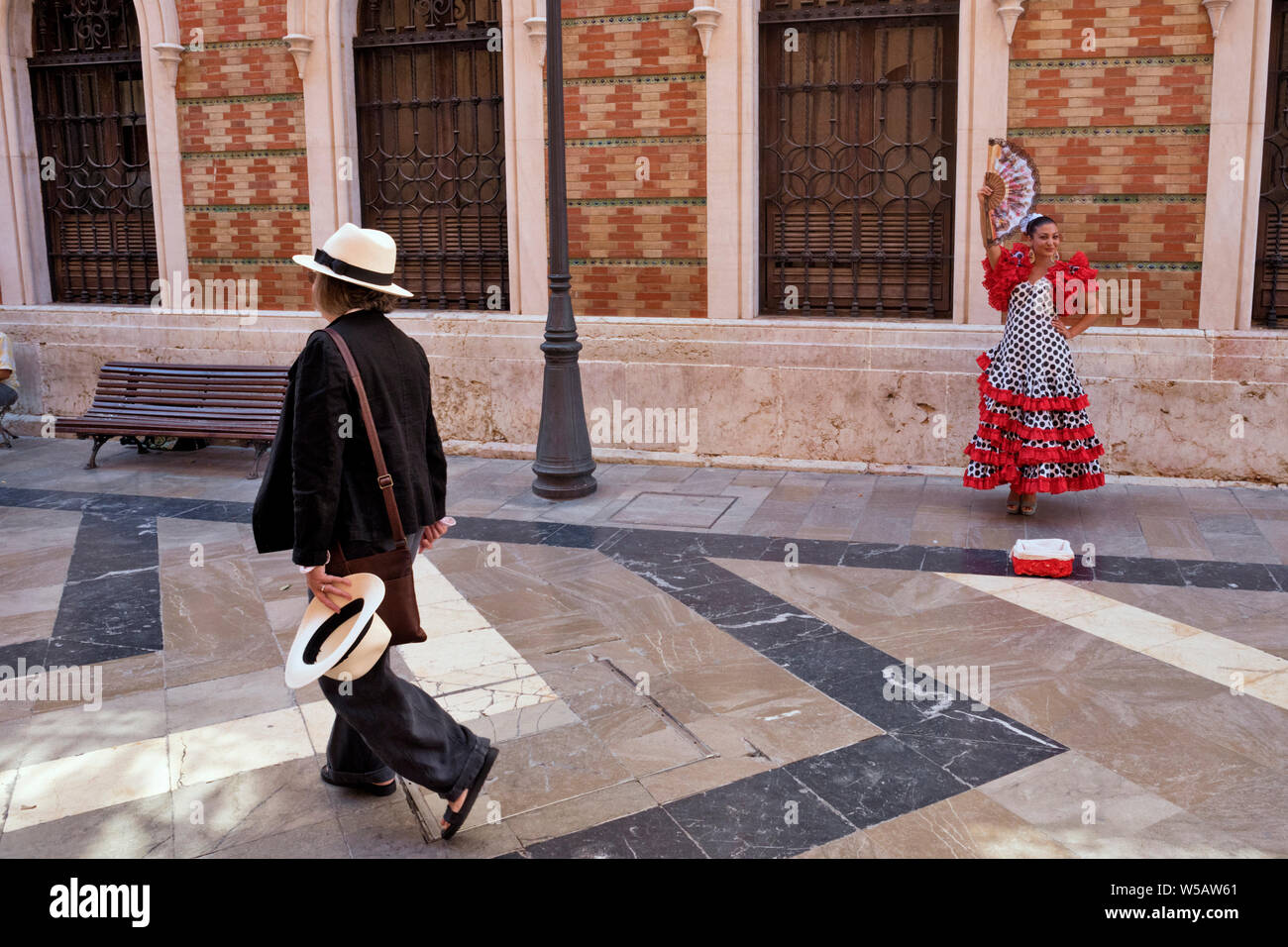 gypsy in costume and a tourist on a street in Malaga, Andalucia, Spain Stock Photo