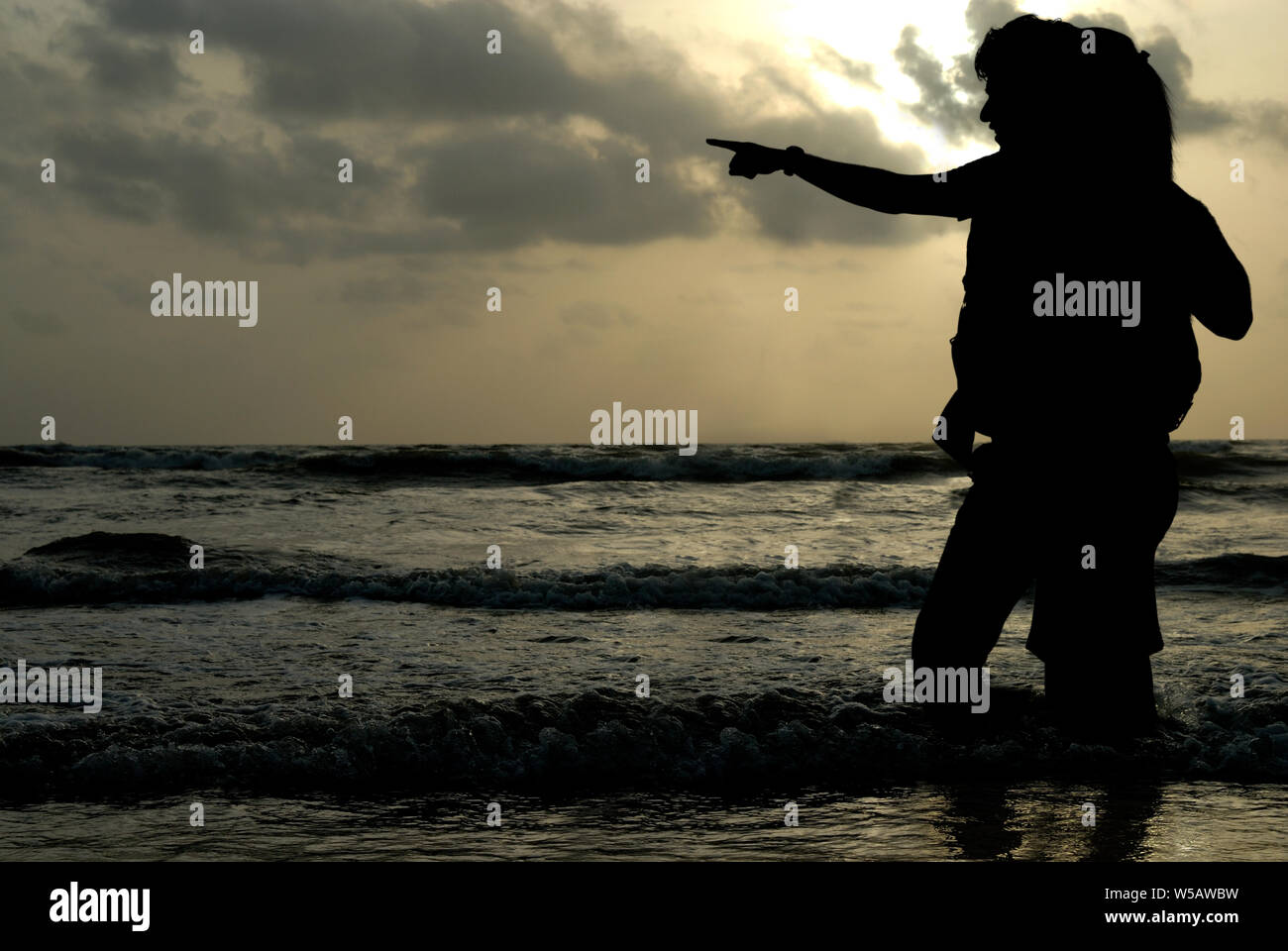Silhouette of couple on the beach Stock Photo - Alamy