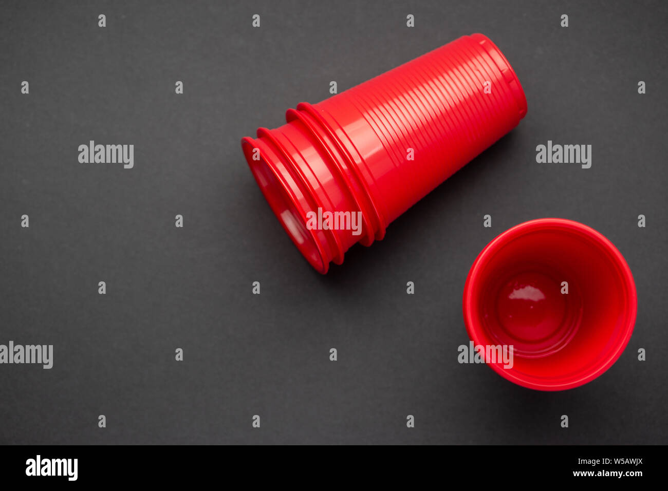 Red plastic glasses on black background, top view Stock Photo