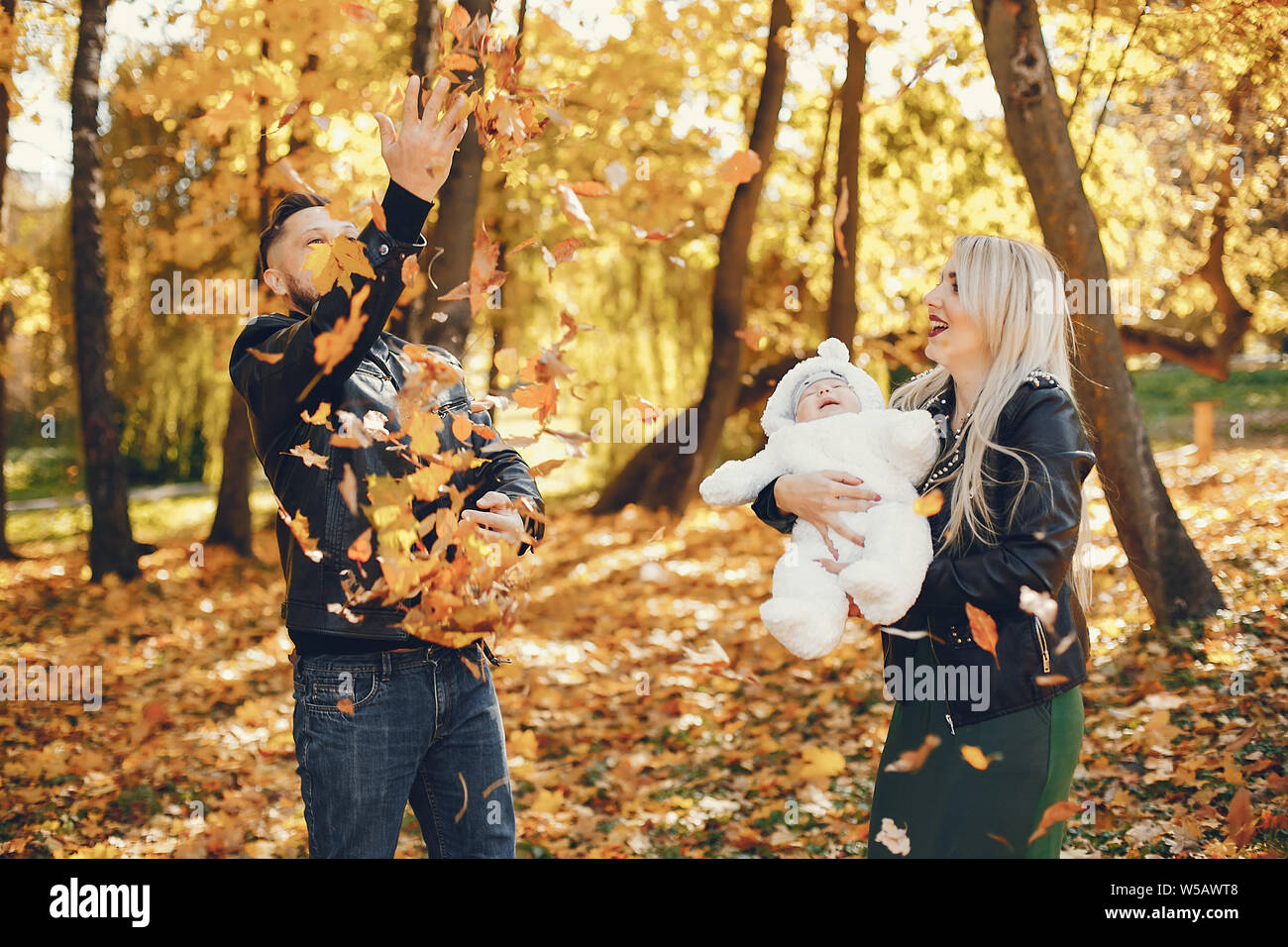 Family with daughter in a autumn park Stock Photo - Alamy
