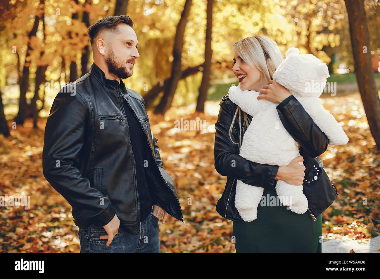 Family with daughter in a autumn park Stock Photo - Alamy