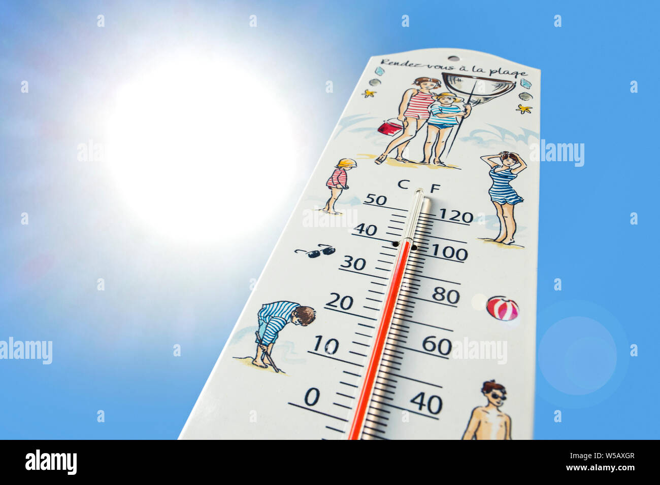 Worm's-eye view of thermometer measures extremely hot temperature of 40 degrees Celsius / 40 °C / 40°C / 100 °F during heatwave / heat wave in summer Stock Photo