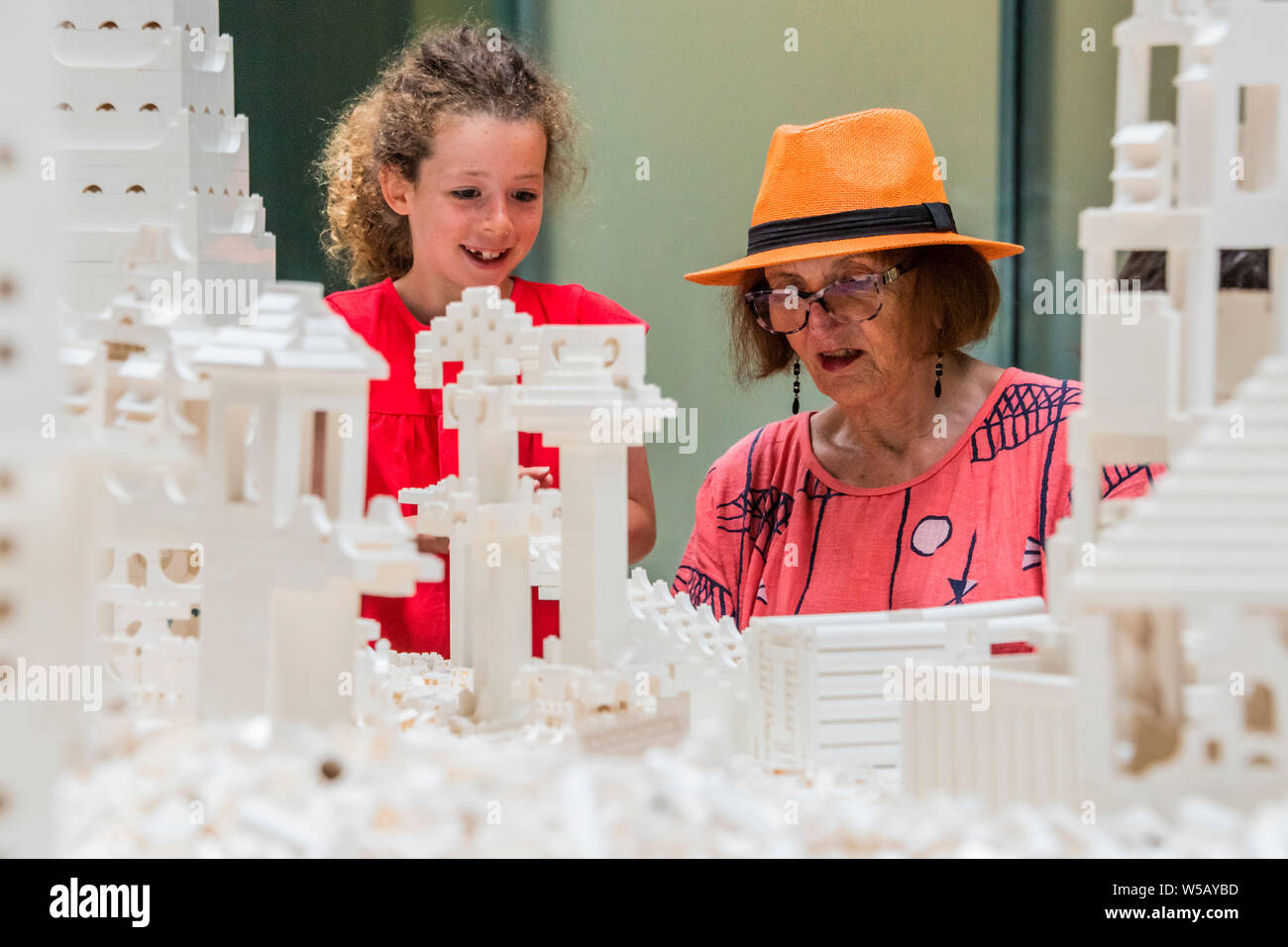 Tate Modern, Southbank, London, 27 Jul 2019 - Olafur Eliasson's The cubic structural evolution project 2004. The work comes to the UK for the first time to coincide with the artist's new exhibition, In real life, at Tate Modern; an unmissable survey spanning over 30 years of Eliasson's career. Taking over the Turbine Hall for three weeks, this free interactive artwork invites visitors to unleash their architectural vision for a future city using over one tonne of white Lego bricks. Credit: Guy Bell/Alamy Live News Stock Photo