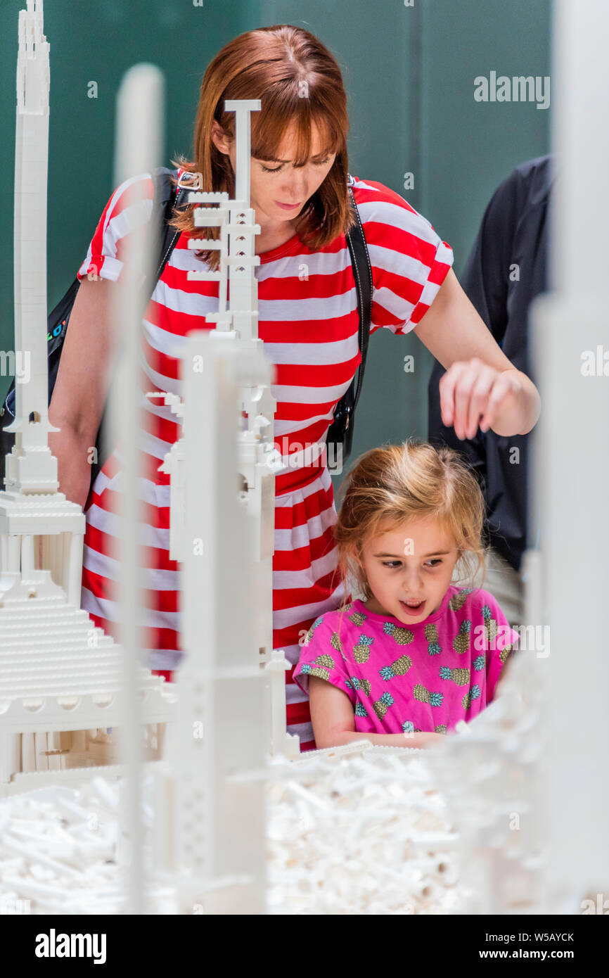 Tate Modern, Southbank, London, 27 Jul 2019 - Olafur Eliasson's The cubic structural evolution project 2004. The work comes to the UK for the first time to coincide with the artist's new exhibition, In real life, at Tate Modern; an unmissable survey spanning over 30 years of Eliasson's career. Taking over the Turbine Hall for three weeks, this free interactive artwork invites visitors to unleash their architectural vision for a future city using over one tonne of white Lego bricks. Credit: Guy Bell/Alamy Live News Stock Photo