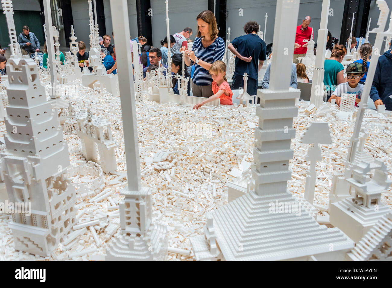 Tate Modern, Southbank, London, 27 Jul 2019 - Olafur Eliasson's The cubic structural evolution project 2004. The work comes to the UK for the first time to coincide with the artist's new exhibition, In real life, at Tate Modern; an unmissable survey spanning over 30 years of Eliasson's career. Taking over the Turbine Hall for three weeks, this free interactive artwork invites visitors to unleash their architectural vision for a future city using over one tonne of white Lego bricks. Credit: Guy Bell/Alamy Live News Stock Photo