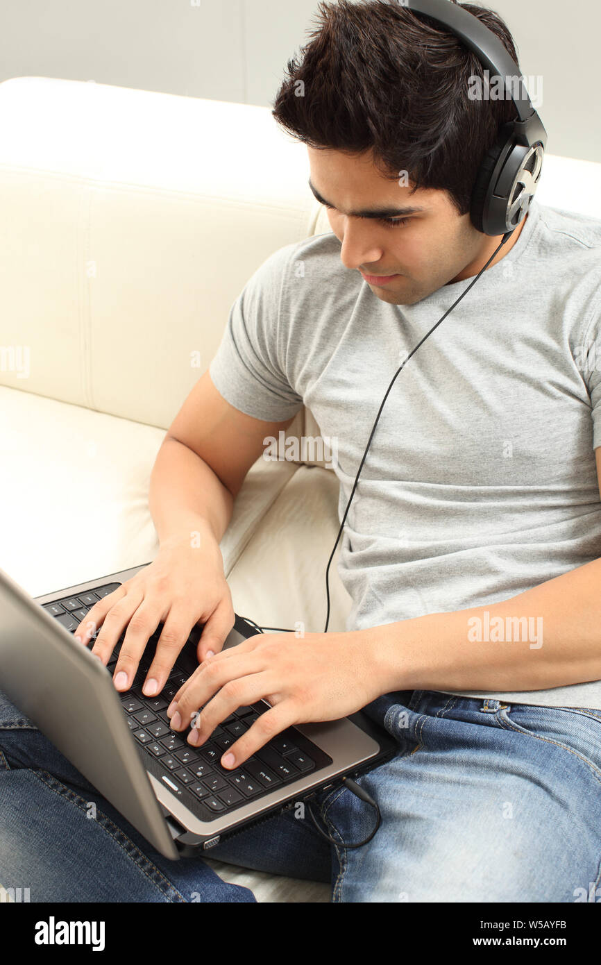 Indian young man wearing headphones hi-res stock photography and images ...