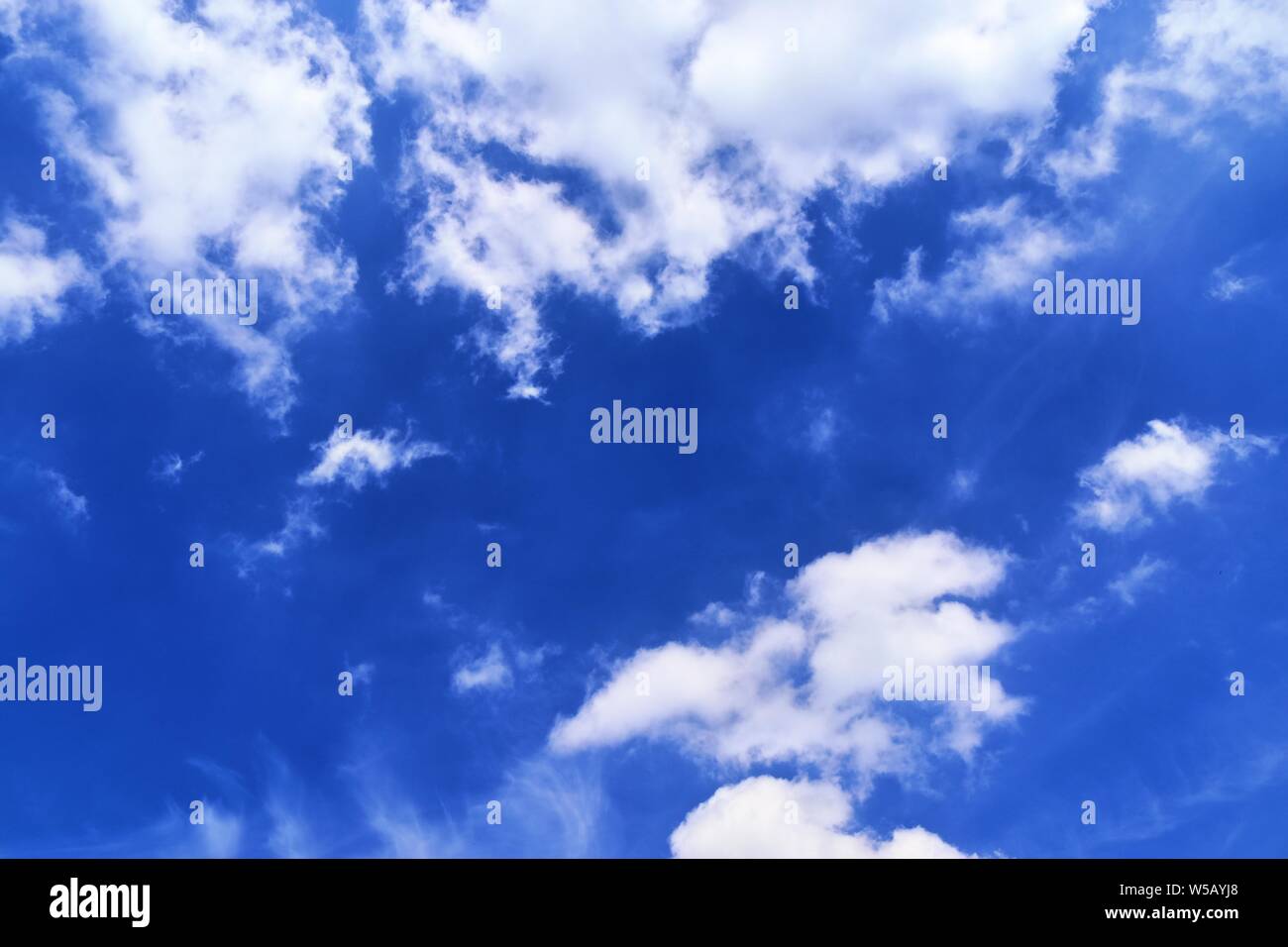 Beautiful white fluffy clouds on a deep blue summer sky Stock Photo - Alamy