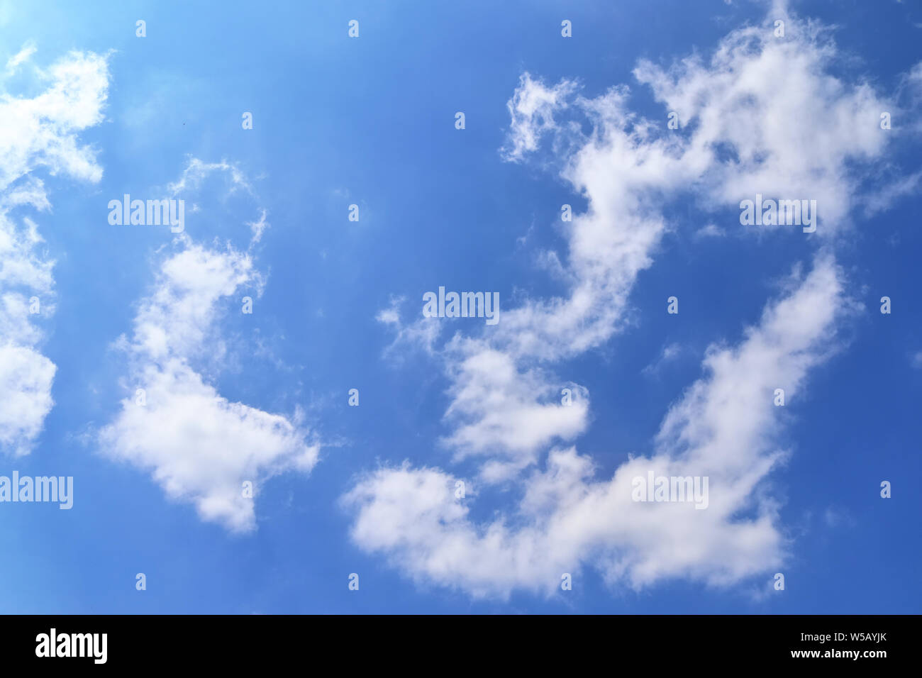 Beautiful white fluffy clouds on a deep blue summer sky Stock Photo - Alamy