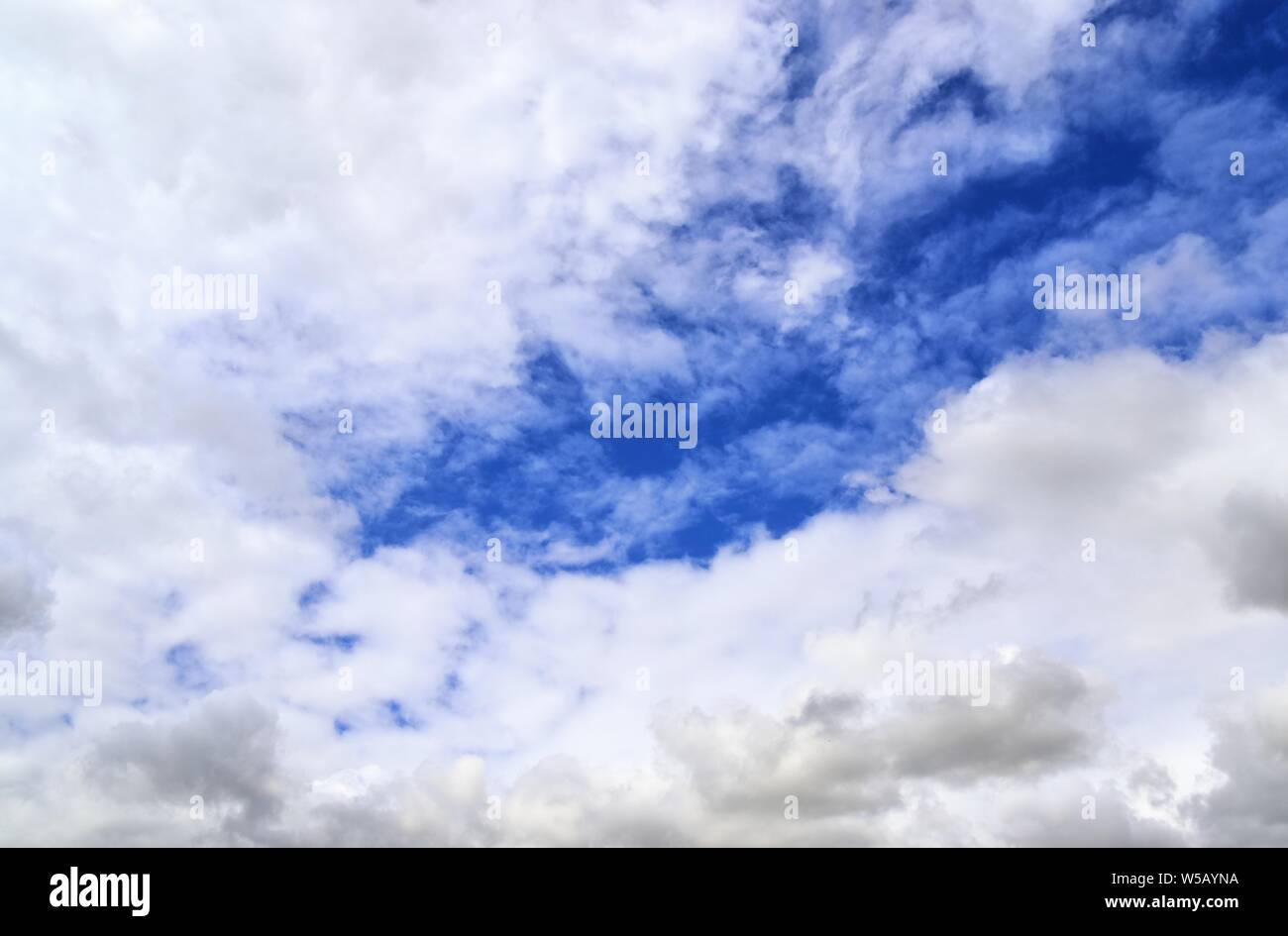Beautiful white fluffy clouds on a deep blue summer sky Stock Photo - Alamy