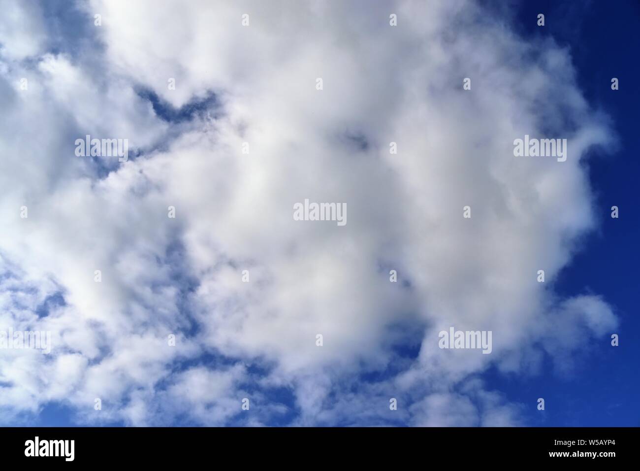 Beautiful white fluffy clouds on a deep blue summer sky Stock Photo - Alamy