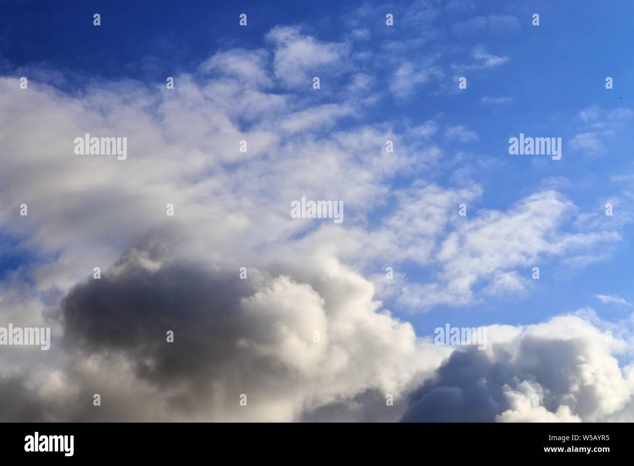 Beautiful white fluffy clouds on a deep blue summer sky Stock Photo - Alamy