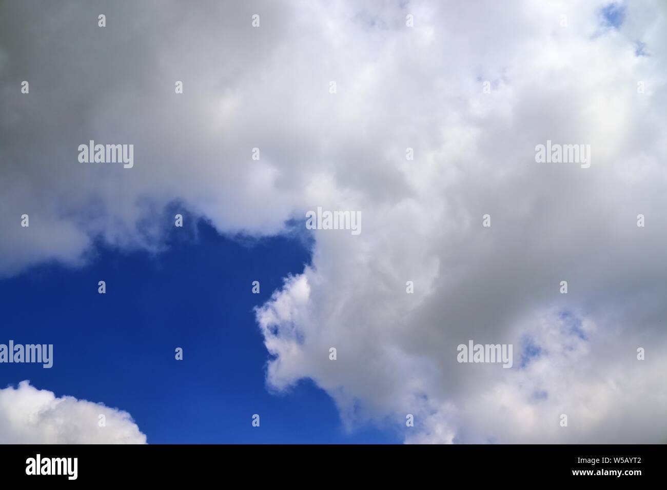 Beautiful white fluffy clouds on a deep blue summer sky Stock Photo - Alamy