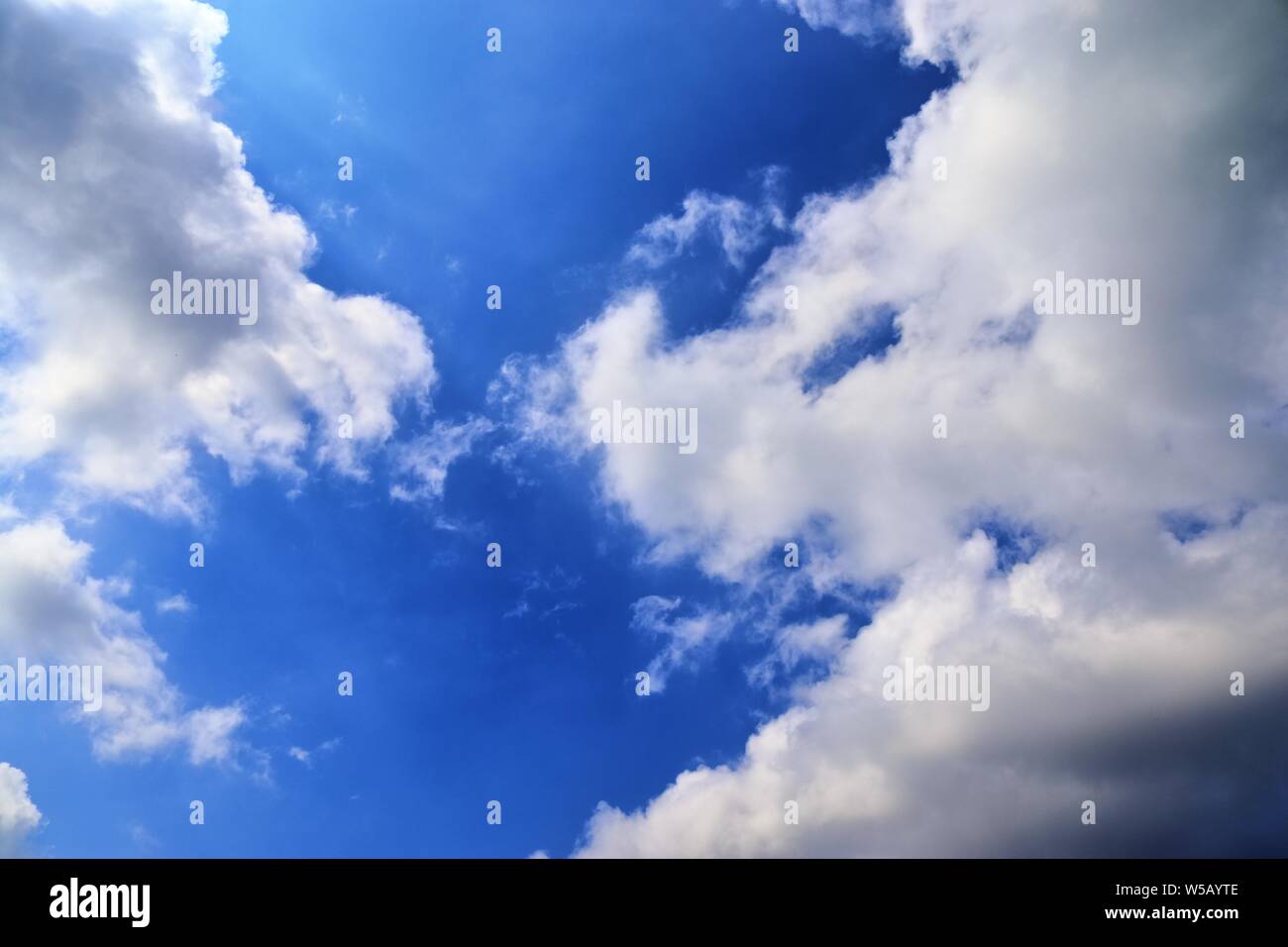Beautiful white fluffy clouds on a deep blue summer sky Stock Photo - Alamy