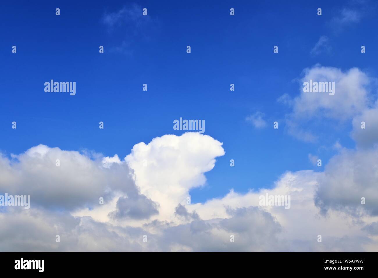 Beautiful white fluffy clouds on a deep blue summer sky Stock Photo - Alamy