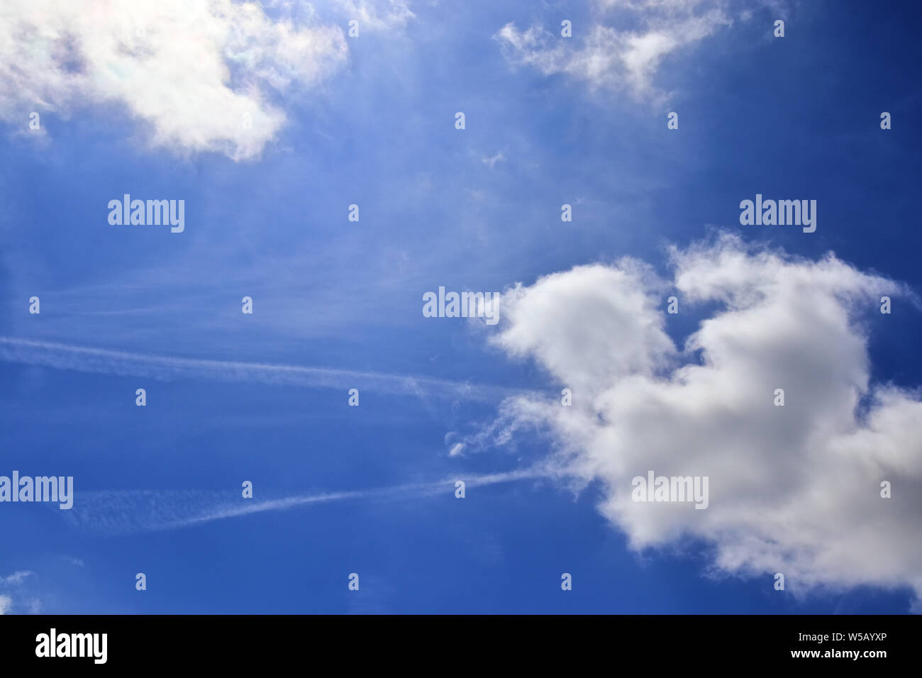 Beautiful white fluffy clouds on a deep blue summer sky Stock Photo - Alamy