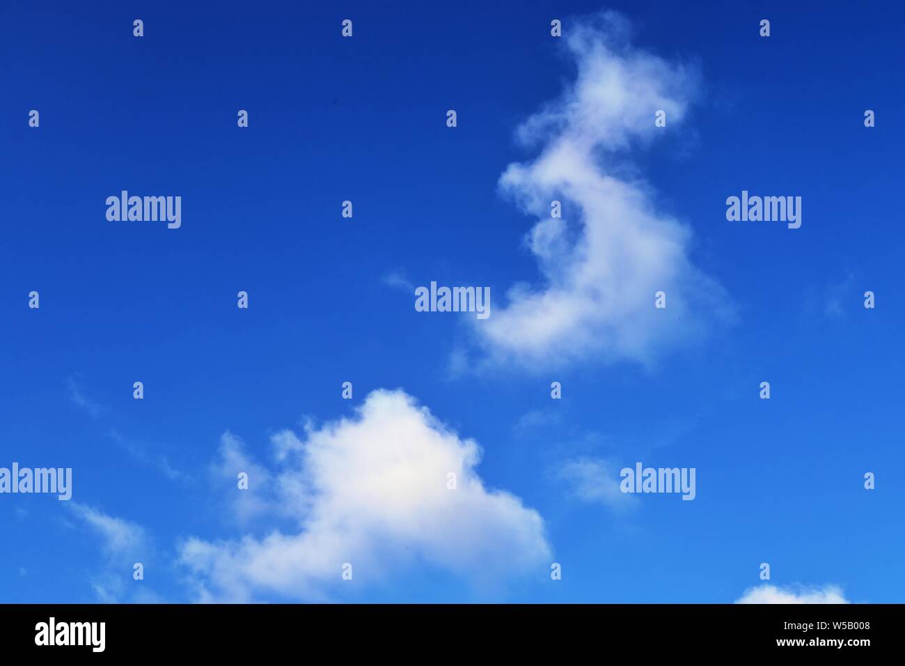 Beautiful white fluffy clouds on a deep blue summer sky Stock Photo - Alamy