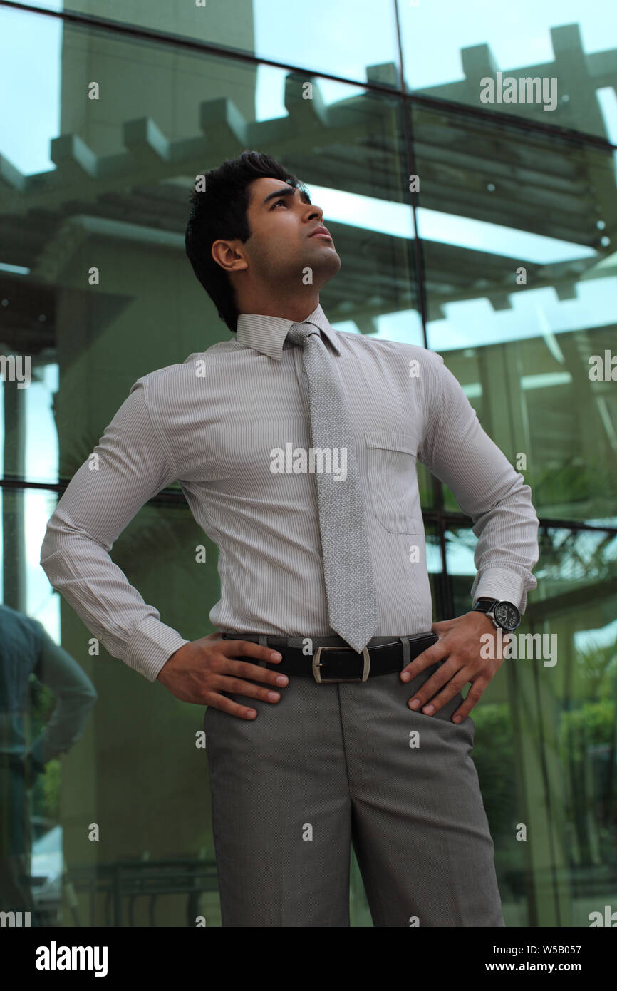 Man In Building Businessman standing in front of an office building Stock Photo - Alamy