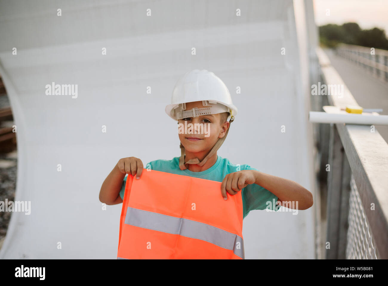 Cute boy engineer on bridge Stock Photo