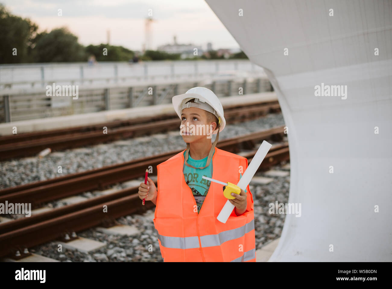 Cute boy engineer on bridge Stock Photo