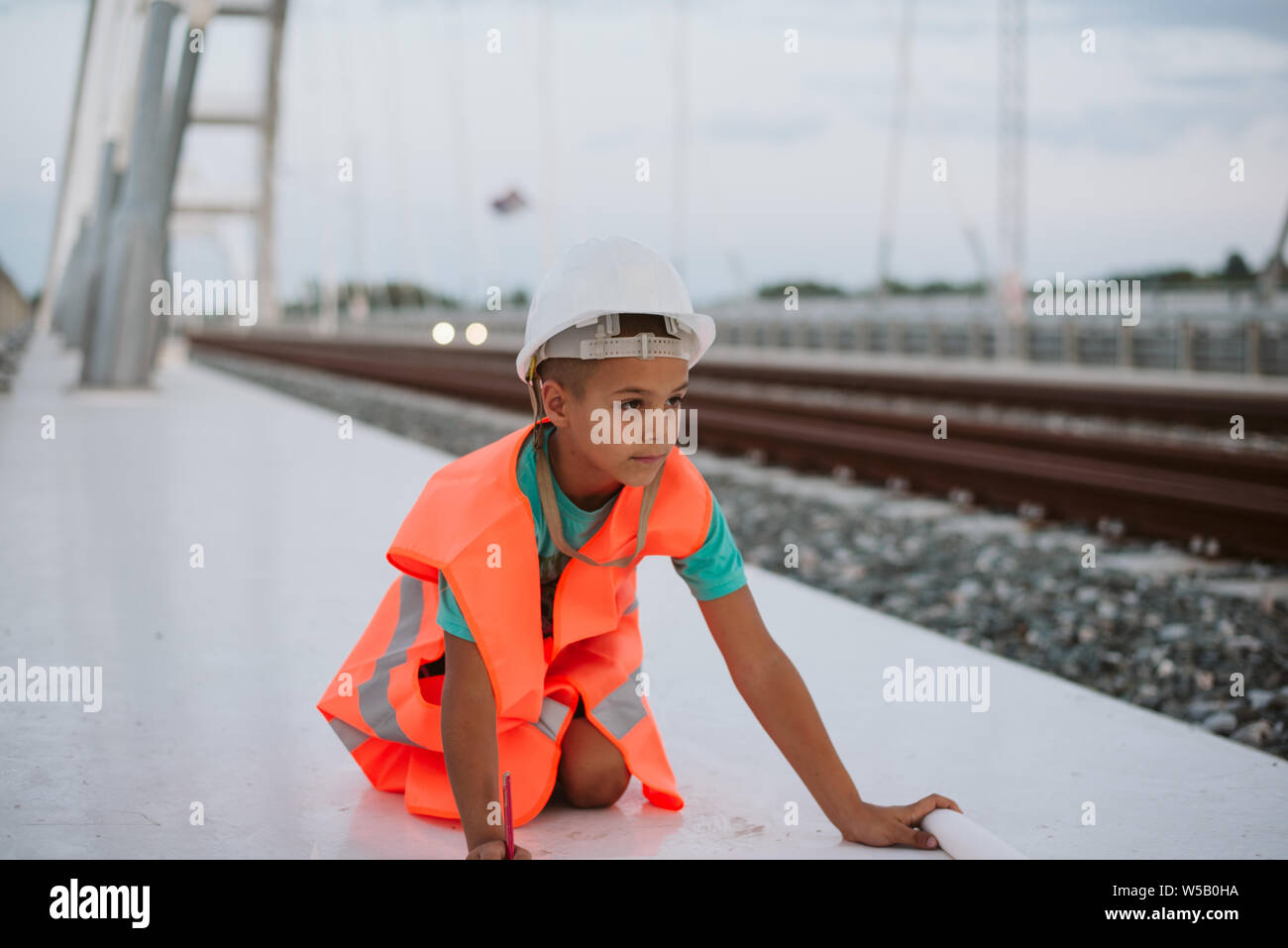 Cute boy engineer on bridge Stock Photo