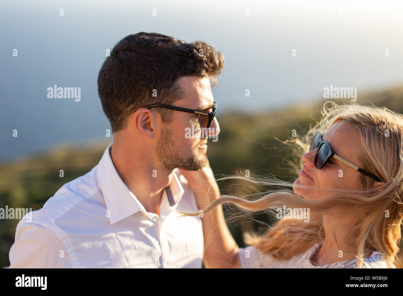 Happy young couple in love smiling in sunset, enjoying moments together Stock Photo