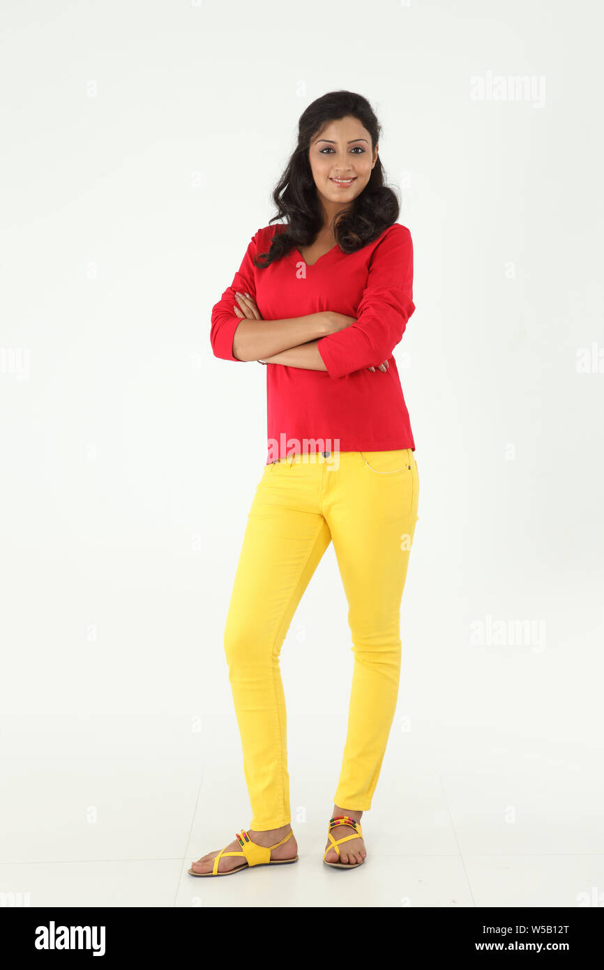 Woman smiling with her arms crossed Stock Photo - Alamy