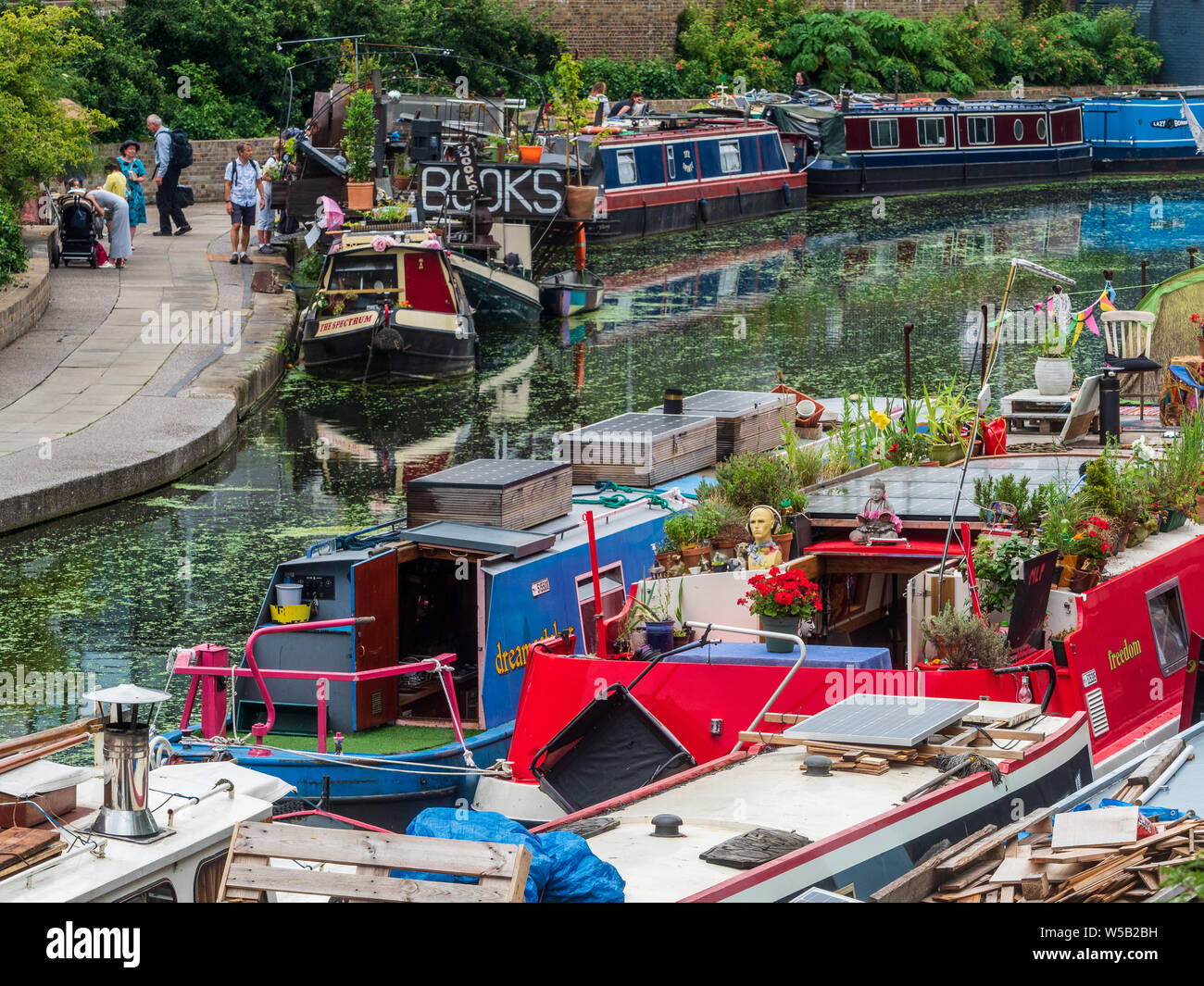 The 'Word On The Water' floating bookshop and other canal boats on London's Regents Canal Towpath near Kings Cross Station. Stock Photo