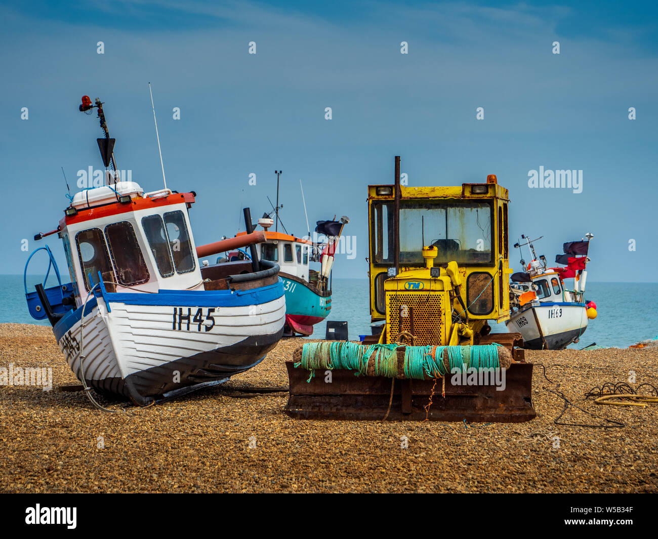 Aldeburgh beach in Suffolk UK  - inshore fishing boats hauled up on the shingle Stock Photo
