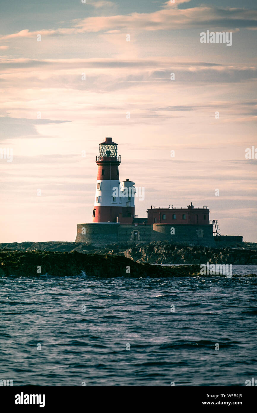 Sunset behind Longstone Lighthouse on the Farne Islands, Northumberland. Stock Photo