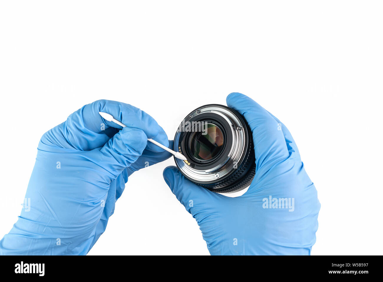 a professional cleaning of a camera lens with a cotton bud and gloves