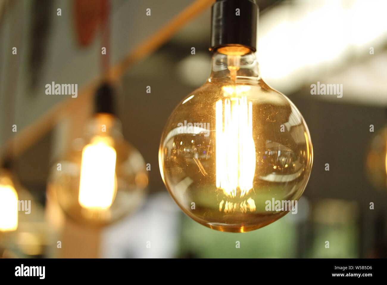 Classic retro incandescent led electric lamp on blurred background Stock Photo