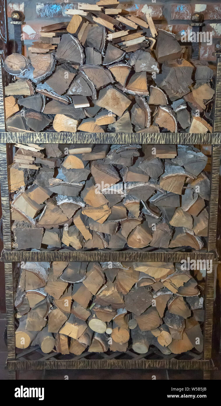 Photo background parts of a wooden trunk folded on a rack vertically in a pile. Stock Photo