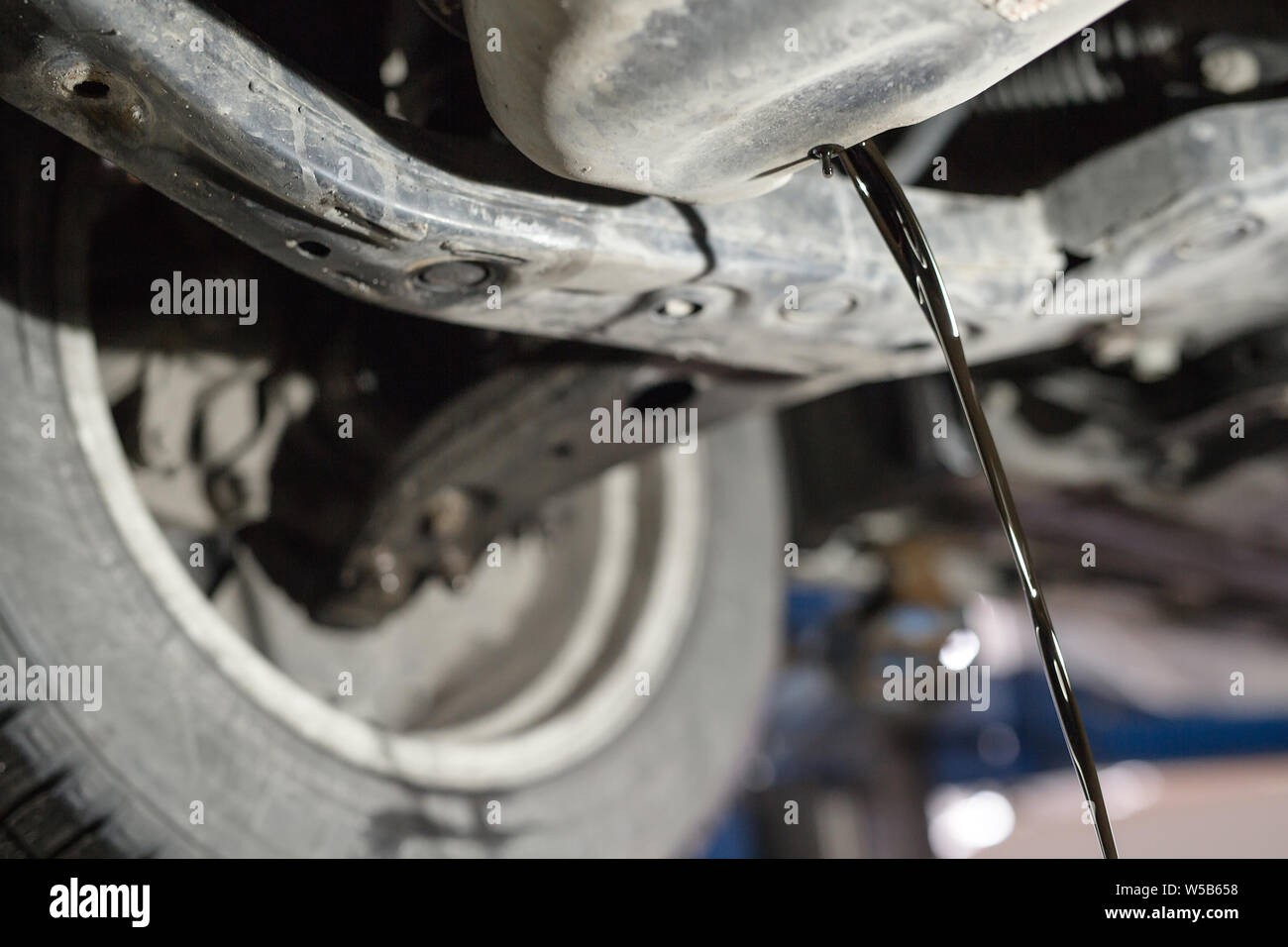 Change the old engine oil for car. Repair service. Stock Photo