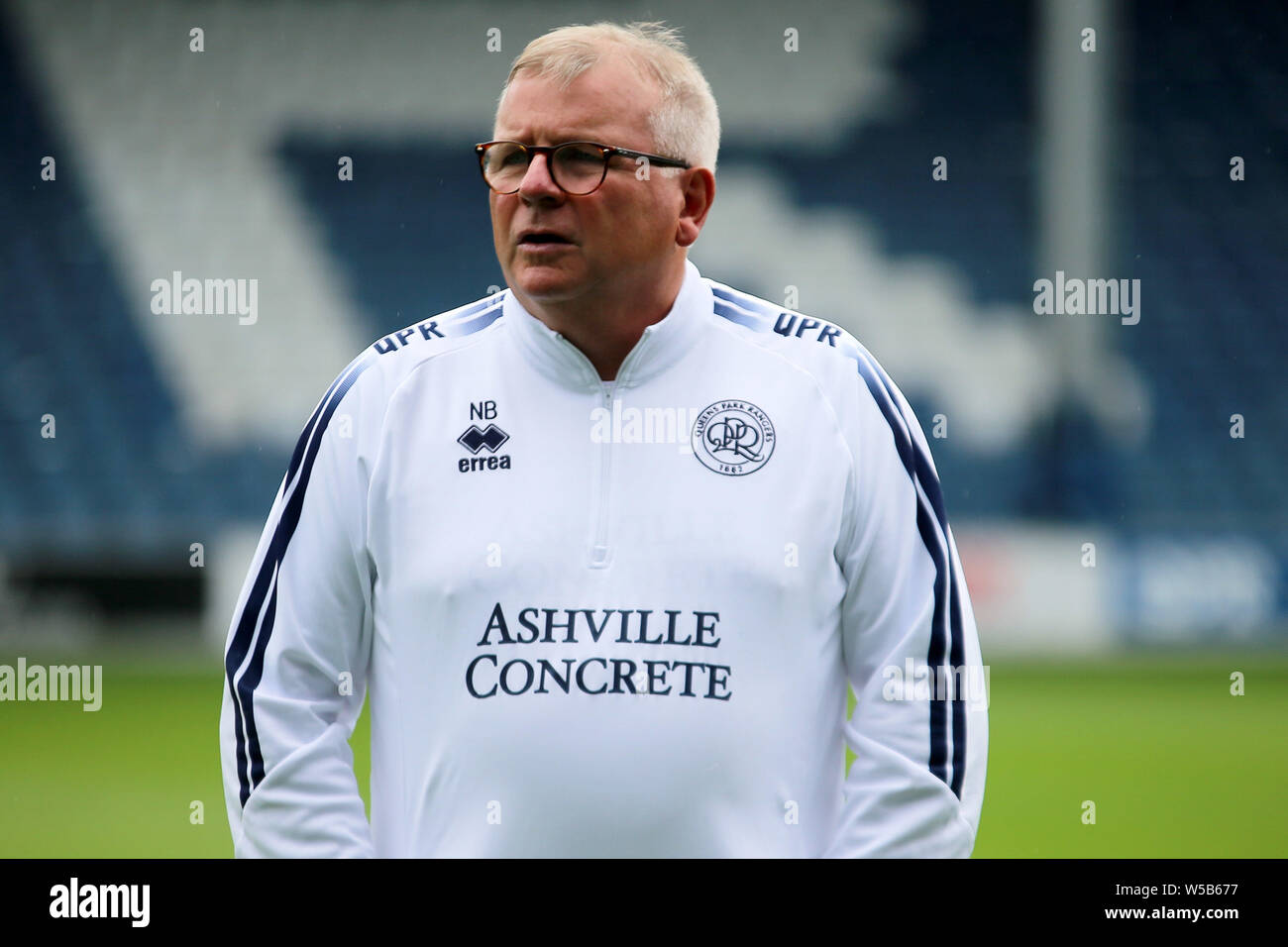 London, UK. 27th July, 2019. Neil Banfield First team Coach of Queens Park Rangers looks on ahead of pre-season football friendly match, Queens Park Rangers v Watford at Loftus Road Stadium in London on Saturday 27th July 2019. this image may only be used for Editorial purposes. Editorial use only, license required for commercial use. No use in betting, games or a single club/league/player publications. pic by Tom Smeeth/Andrew Orchard sports photography/Alamy Live news Credit: Andrew Orchard sports photography/Alamy Live News Stock Photo