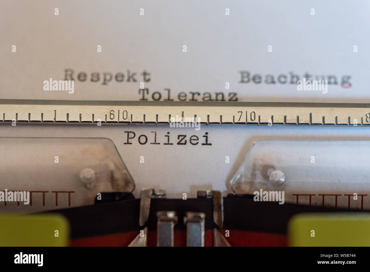 Typewriter with a leaf and the words Respekt, Beachtung, Toleranz und Polizei  (Respect, compliance, Tolerance and traffic) Stock Photo