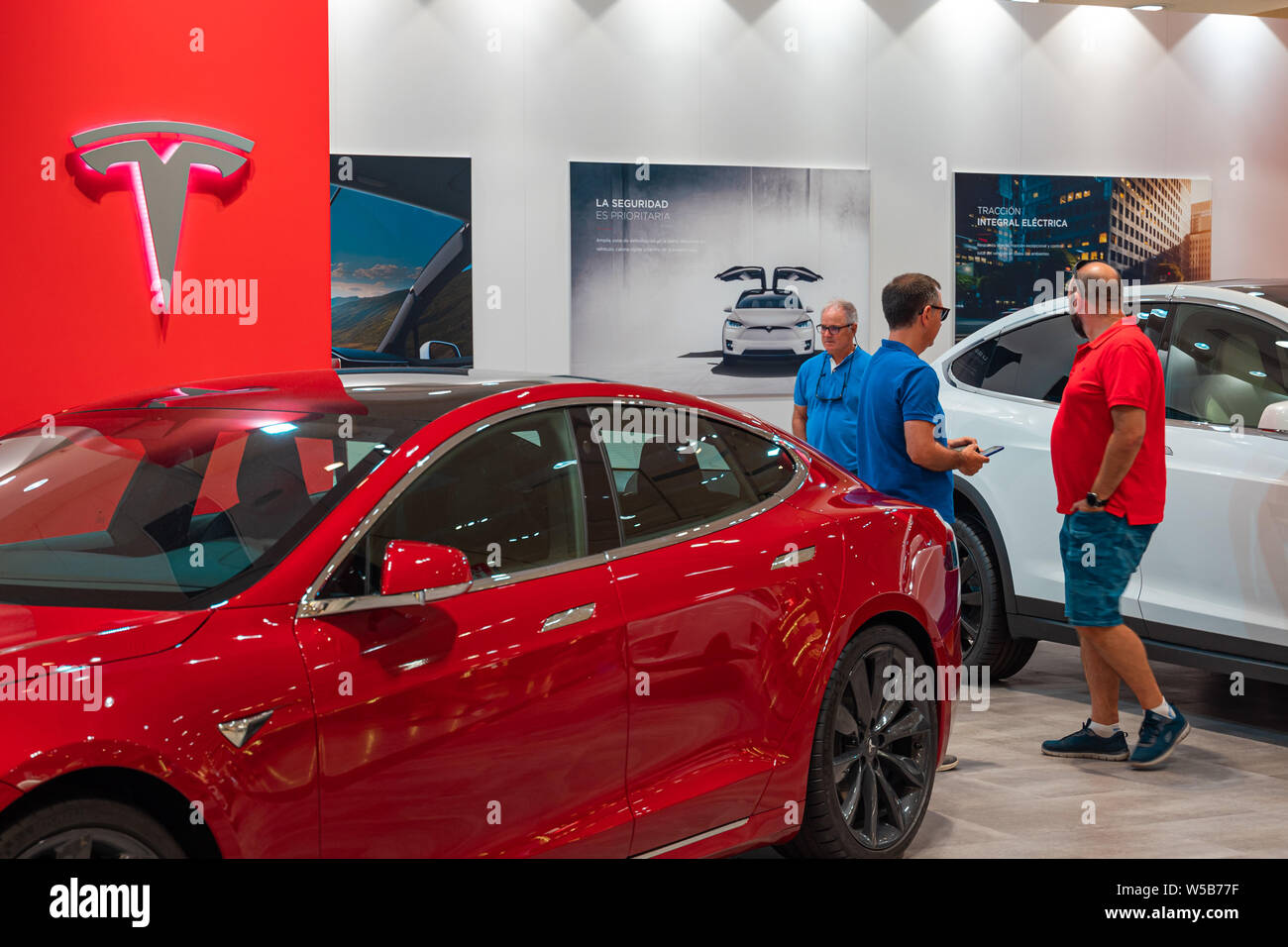 Valencia, Spain July 21, 2019 Two buyers of a Tesla Model S electric car on display at