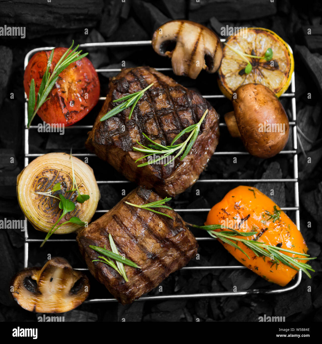 Grill grate with freshly cooked meat and vegetables on coal Stock Photo